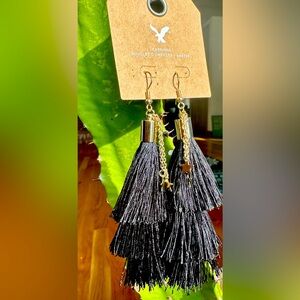 American eagle black tassel earrings with gold stars.
